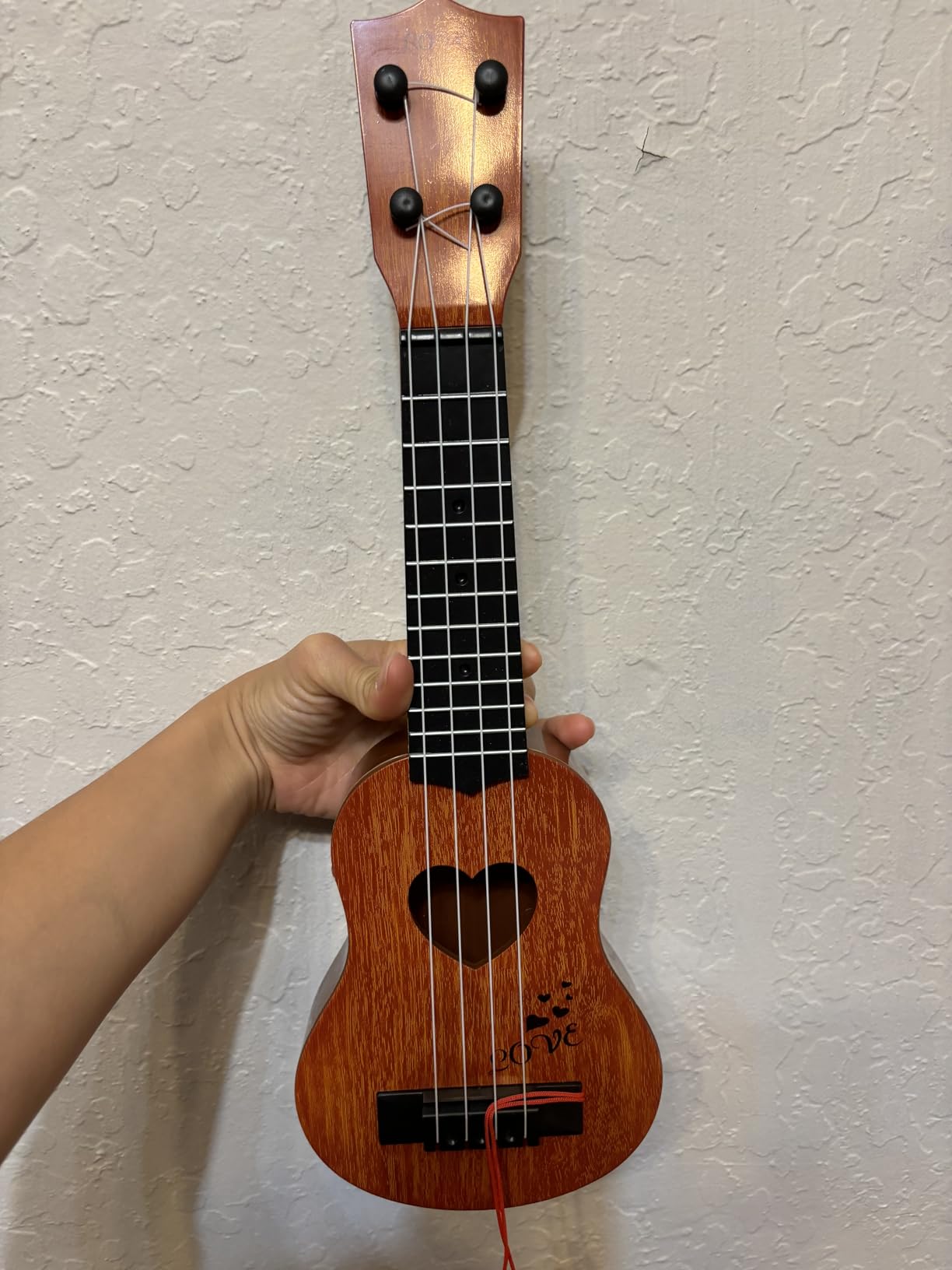 YEZI Kids Toy Classical Ukulele Guitar Musical Instrument, Brown Customer Review YEZI Kids Toy Classical Ukulele Guitar Musical Instrument, Brown - Customer Photo 2